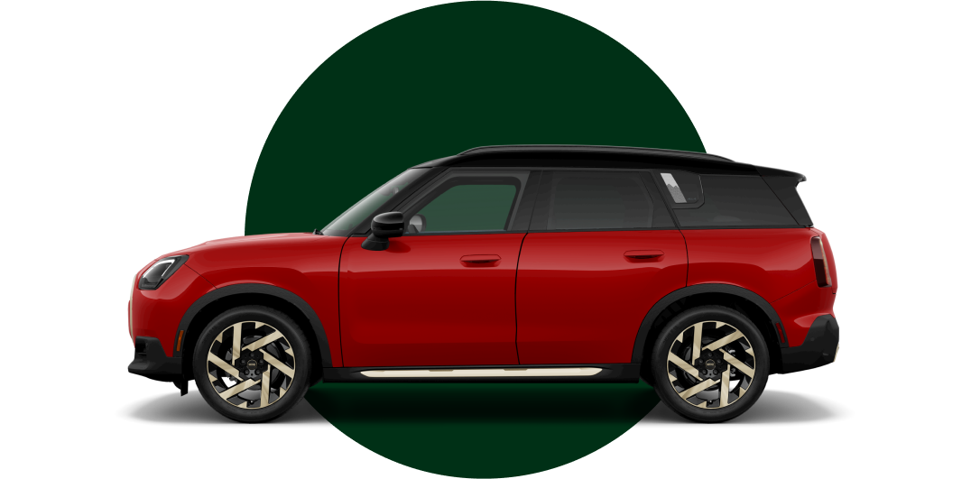  Side view of a MINI Countryman SE ALL4 in the Chili Red II body color, facing left with its shadow underneath it.