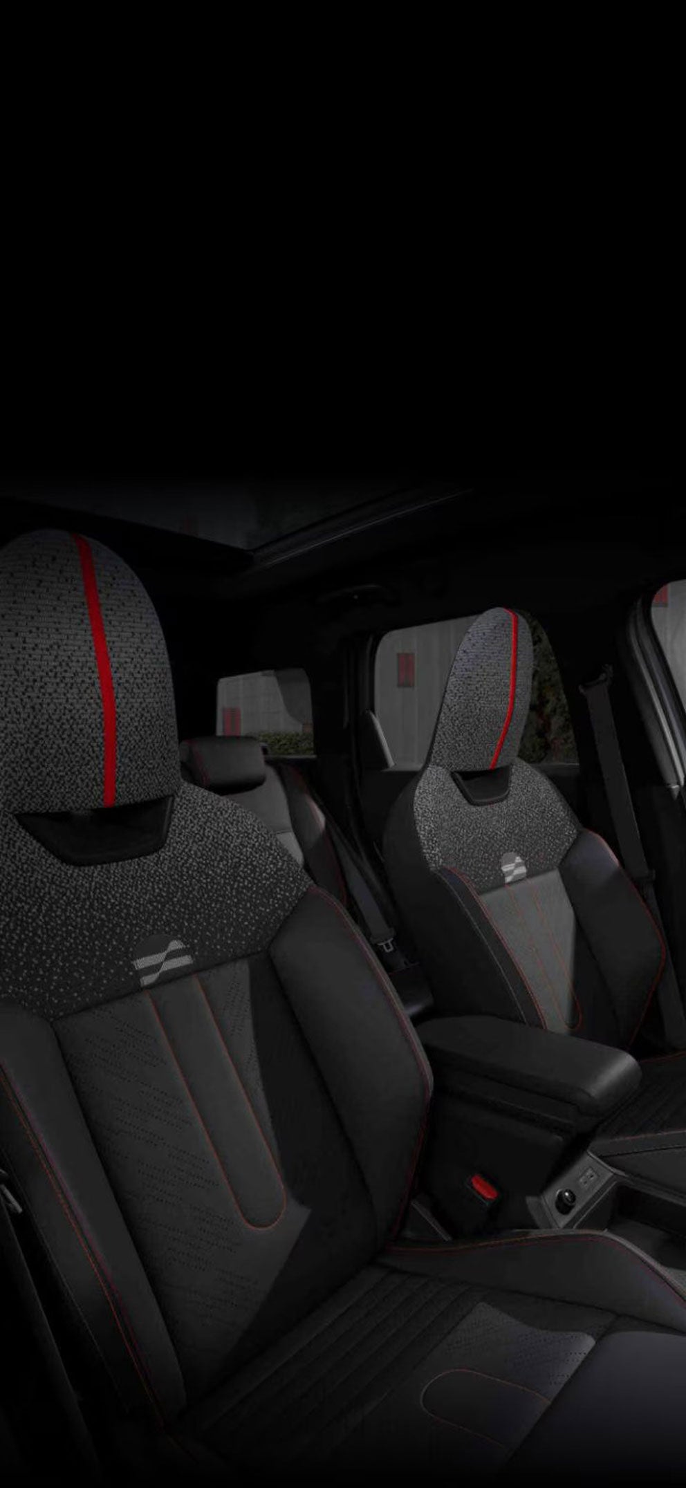 An angled-view of the inside of the MINI JCW Countryman ALL4 taken from the passenger's side showcasing the front JCW Sports Seats. 