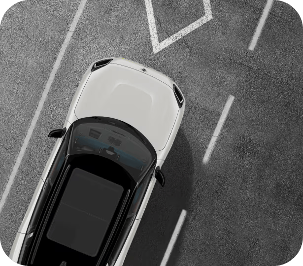 Overhead view of a white MINI vehicle with white roof parked on a pavement surface with white lane lines on each side of the vehicle.