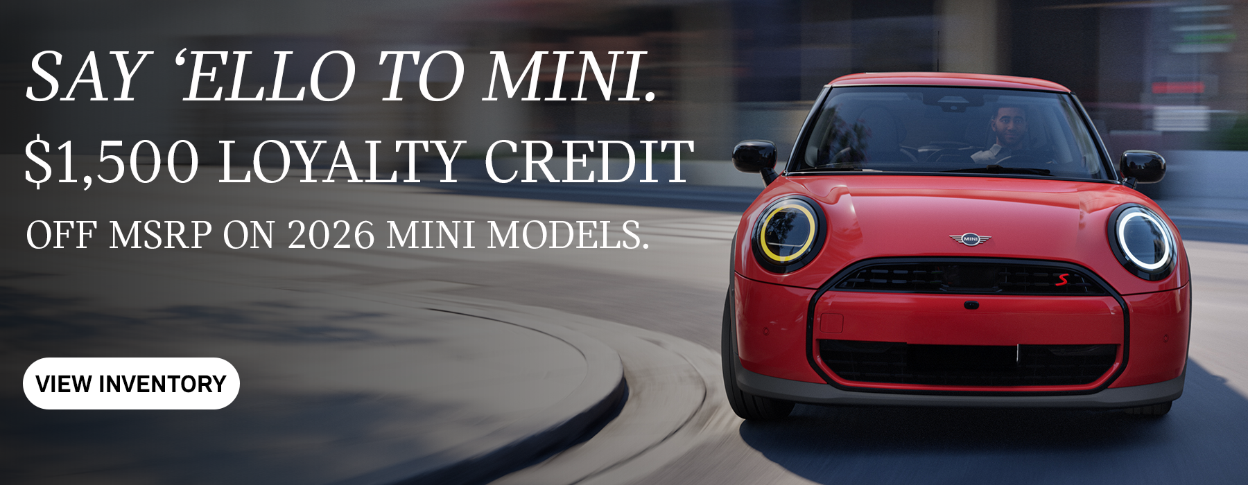 Front view of red MINI cooper curving corner.